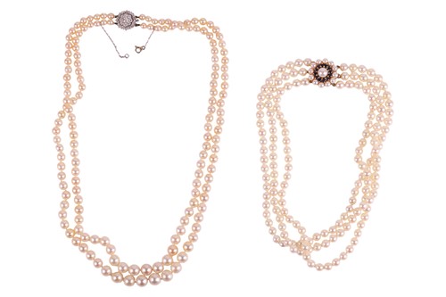 Lot 114 - A double-strand cultured pearl and diamond...