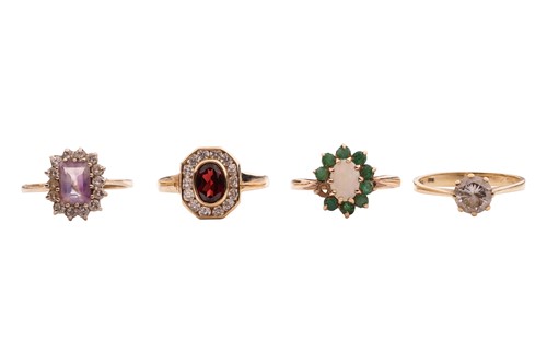 Lot 72 - Four gem-set rings in 9ct gold; a CZ solitaire,...