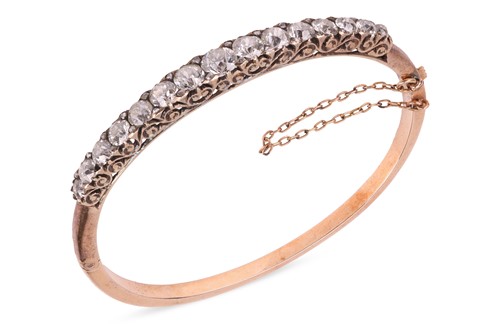 Lot A late Victorian half hoop diamond bangle, the...