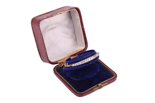Lot A late Victorian half hoop diamond bangle, the...