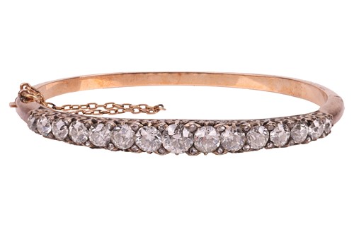 Lot A late Victorian half hoop diamond bangle, the...