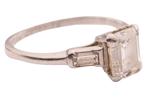 Lot An emerald-cut diamond solitaire ring,...