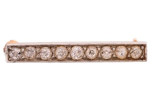 Lot A diamond-set bar brooch, set with nine...