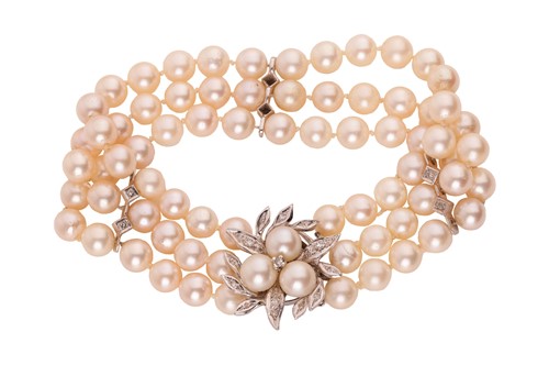 Lot 254 - A three-row cultured pearl and diamond...