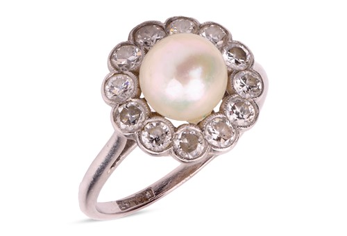 Lot 77 - A pearl and diamond cluster ring, the pearl...