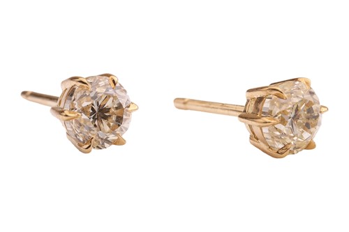 Lot A pair of diamond stud earrings, with a total...