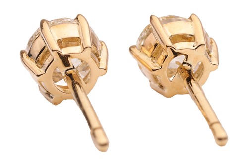 Lot A pair of diamond stud earrings, with a total...