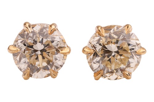 Lot A pair of diamond stud earrings, with a total...