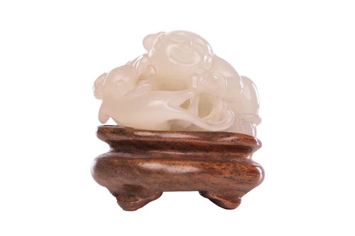 Lot A Chinese pale green jade carved figure of a...