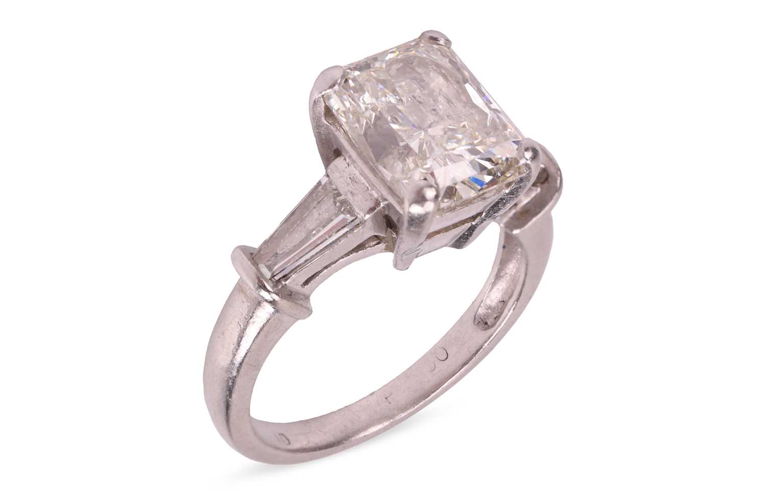 Lot A radiant-cut diamond ring, the central...