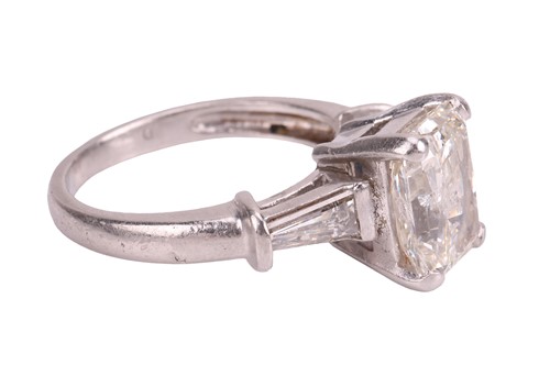 Lot A radiant-cut diamond ring, the central...