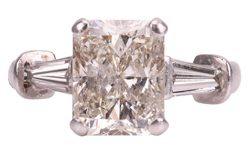 Lot A radiant-cut diamond ring, the central...