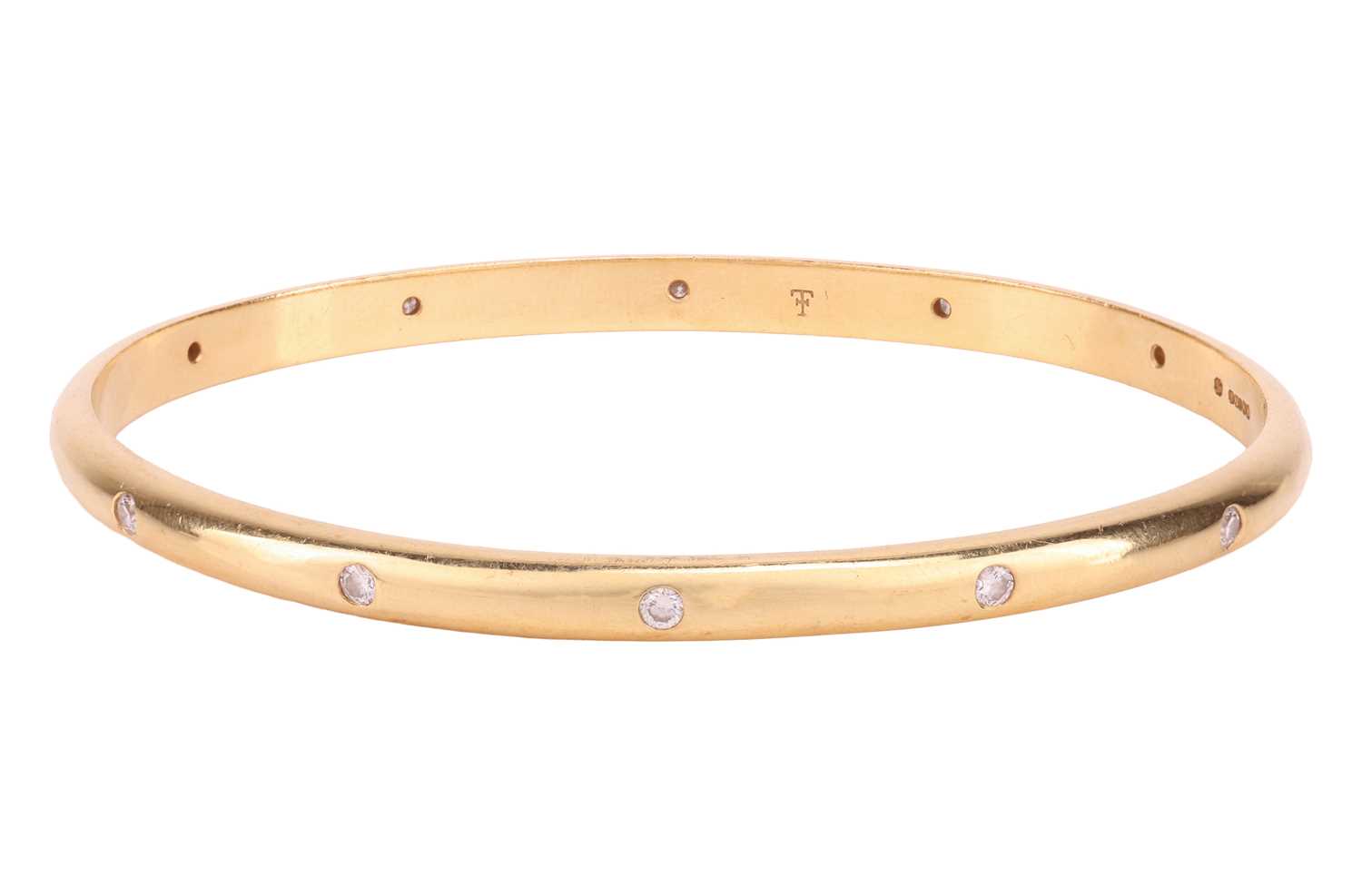 Lot 227 - Theo Fennell - A diamond-set closed bangle in...