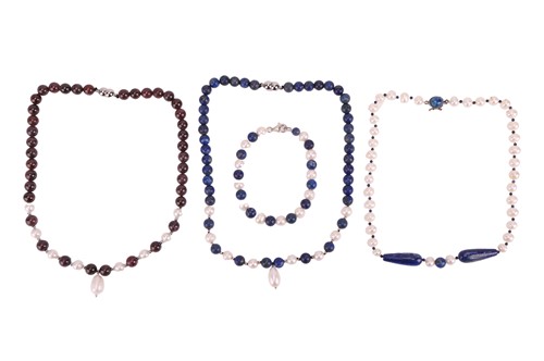 Lot 198 - A group of necklaces and a bracelet, the first...