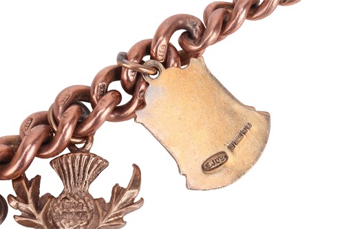 Lot 134 - A charm bracelet, the flat curb-link chain...