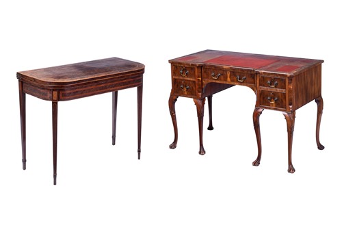 Lot 83 - A walnut kneehole desk, with red leather top...