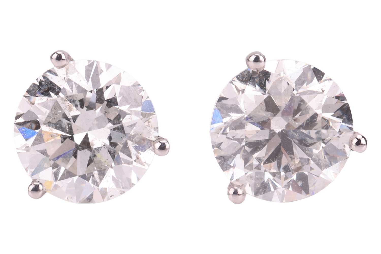 Lot A pair of diamond stud earrings, with an...