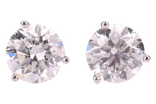 Lot A pair of diamond stud earrings, with an...