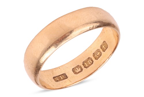 Lot A wide wedding band in 18ct yellow gold, the...