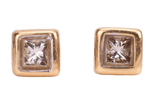 Lot 215 - A pair of princess-cut diamond stud earrings,...