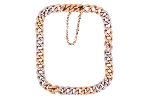 Lot A two-tone curb link bracelet, comprising a...
