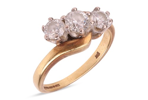 Lot 259 - A three-stone diamond cross-over ring,...