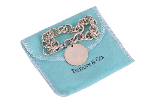 Lot 79 - Tiffany & Co. - a silver bracelet with round...