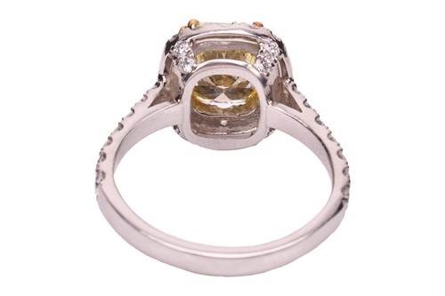 Lot A yellow diamond halo ring, the central...
