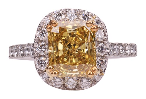 Lot A yellow diamond halo ring, the central...