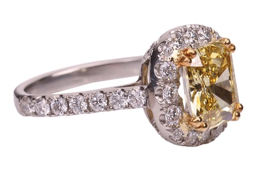 Lot A yellow diamond halo ring, the central...