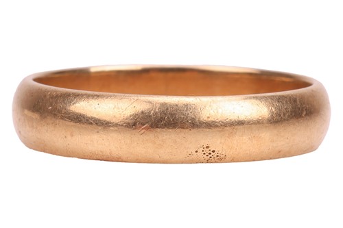 Lot A plain wedding band, consisting of a polished...