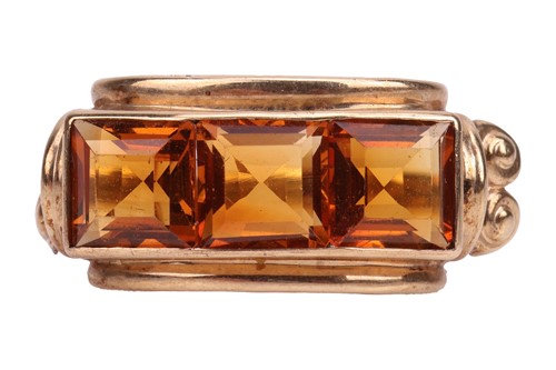 Lot 1 - A citrine three-stone dress ring, channel-set...