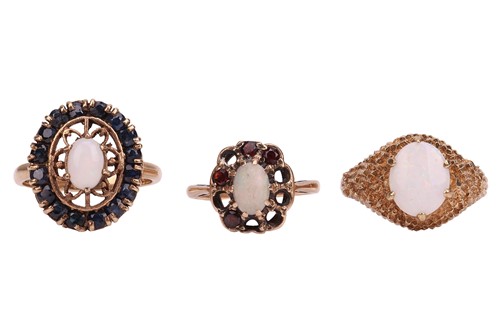 Lot 58 - Three opal dress rings; The first an opal and...