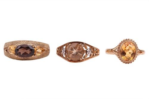 Lot 63 - Three dress rings, comprising a smoky quartz...