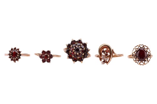 Lot 70 - A small group of garnet-set dress rings,...