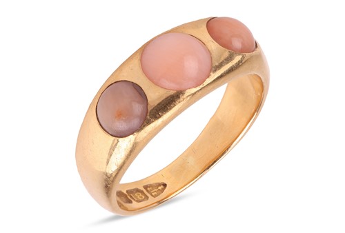 Lot An angel’s skin coral three-stone ring in 18ct...