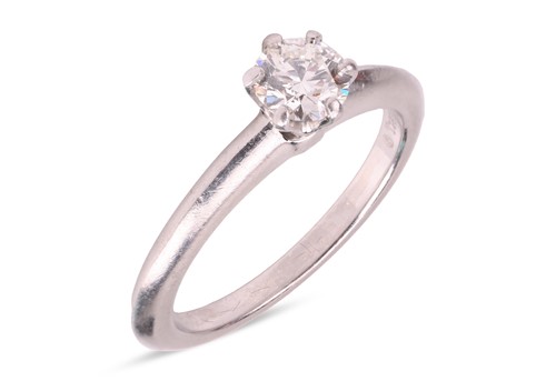 Lot 239 - Tiffany & Co. - A diamond solitaire ring, claw-...