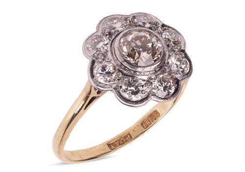 Lot 95 - A diamond cluster ring, featuring a central...