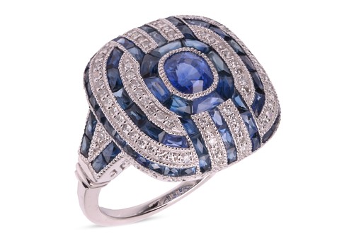 Lot A panel ring set with sapphire and diamond,...