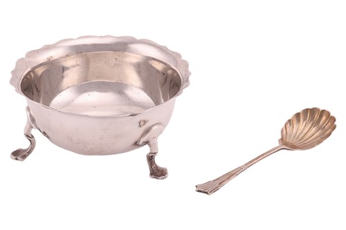 Lot 246 - A silver sugar bowl with shaped rim, on three...