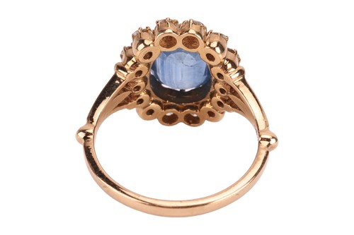 Lot A sapphire and diamond halo ring, centred with...