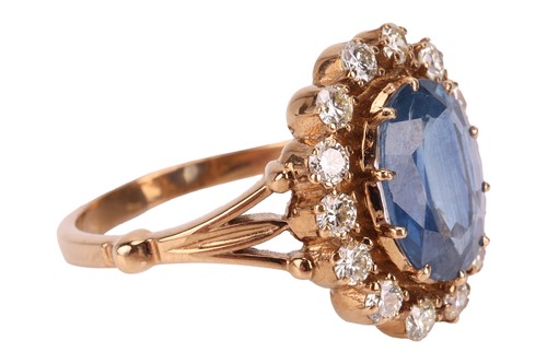 Lot A sapphire and diamond halo ring, centred with...