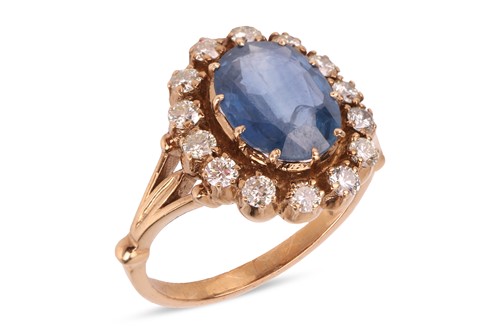 Lot A sapphire and diamond halo ring, centred with...