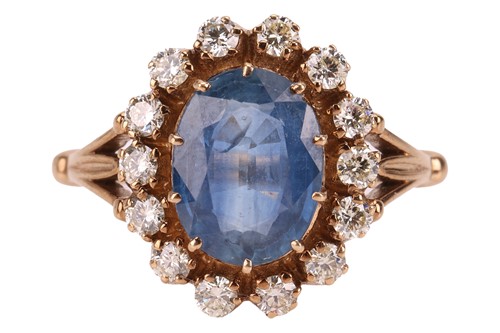 Lot A sapphire and diamond halo ring, centred with...