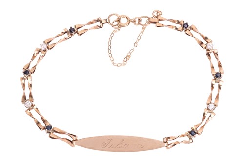 Lot 137 - A gem-set name tag bracelet in 9ct gold, the...