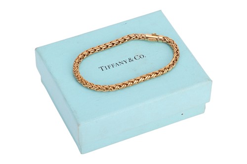 Lot 234 - Tiffany & Co. - A braided wheat link bracelet...