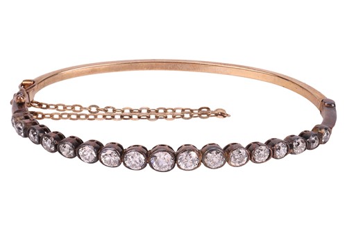 Lot 59 - A diamond hinged bangle, pinched collet-set to...
