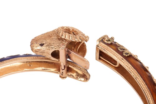Lot 126 - A bangle and a ring of rams head motif design,...