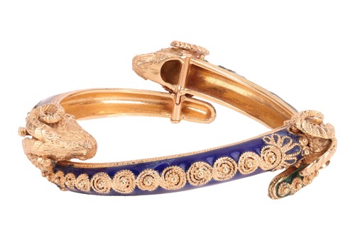 Lot 126 - A bangle and a ring of rams head motif design,...