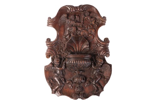 Lot 111 - A Continental carved walnut wall fount,...